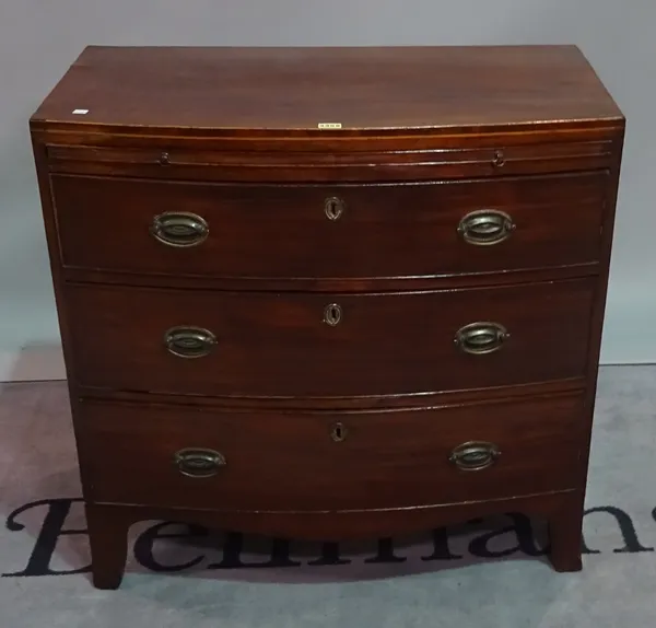 A late George III mahogany bowfront chest, the brushing slide over three long drawers, 83cm wide x 81cm high.