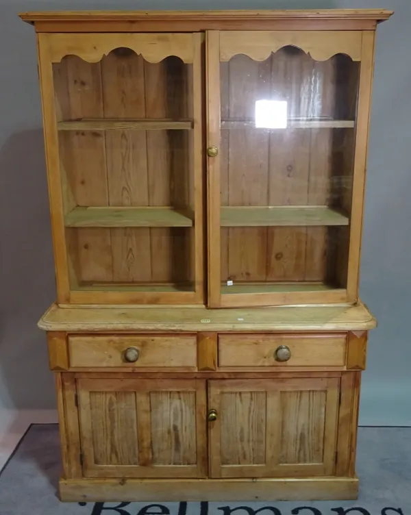 An early 20th century pine display cabinet, over two short drawers and cupboard base, 117cm wide x 188cm high.