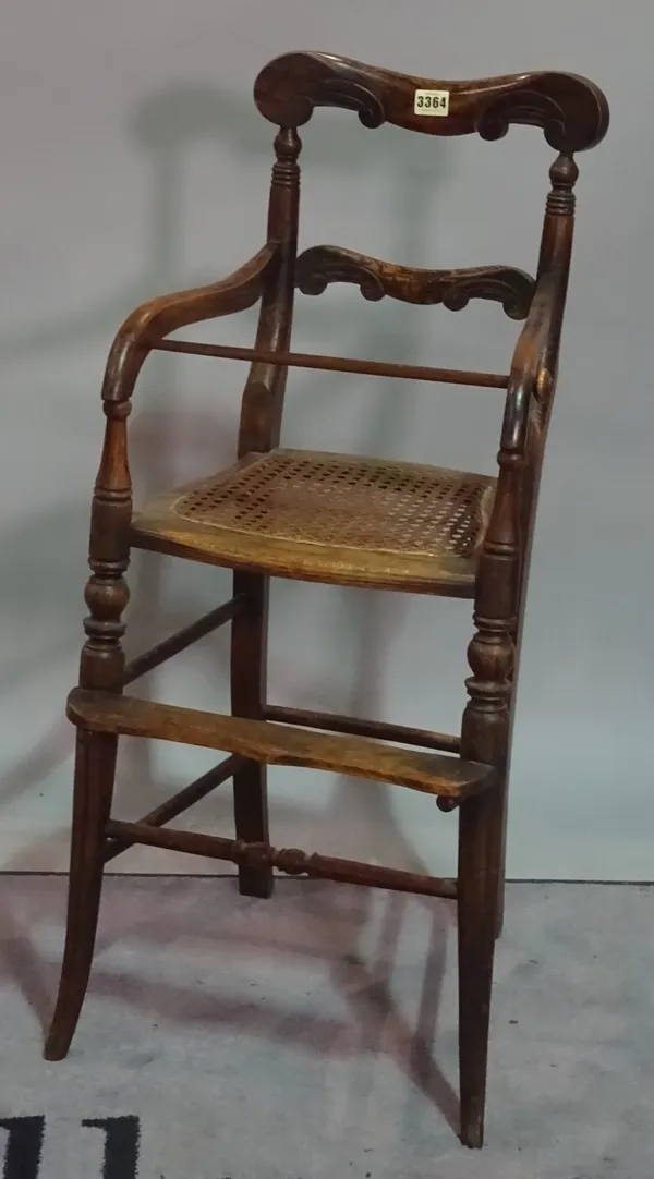 A 19th century faux rosewood child's high chair, on splayed supports, 38cm wide x 88cm high, together with a rush seated ladder back chair, 45cm wide