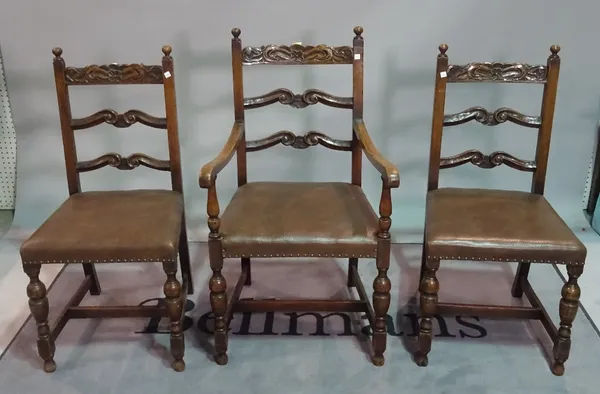 A set of three Charles II style oak ladder back dining chairs, to include a carver, together with two 19th century carved oak chairs, (5).