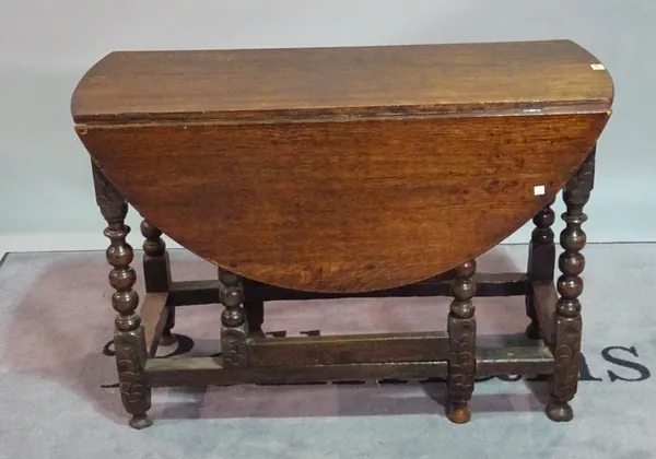 A 17th century style oak drop flap gateleg table, on floral carved supports, 108cm wide x 74cm high.