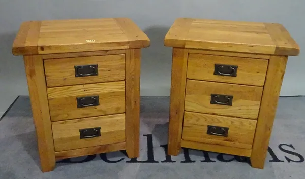 A pair of modern oak three drawer bedside chests, 53cm wide x 62cm high.