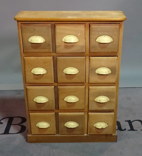 A modern beech bank of three rows of four drawers on plinth base, 64cm wide x 88cm high.