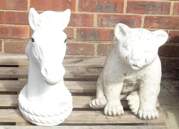 A modern white painted reconstituted stone bear, 43cm high, and a white painted reconstituted horses head, 49cm high, (2).