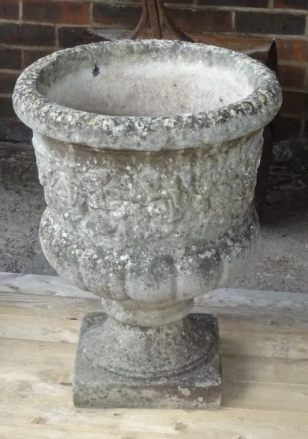 A reconstituted stone jardiniere, with floral moulded body and turned socle, 50cm diameter x 63cm high.