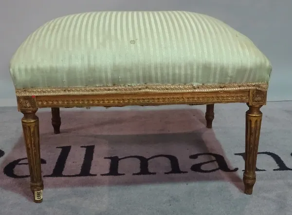 A Louis XVI style giltwood rectangular footstool, on fluted tapering supports, 65cm wide x 40cm high.