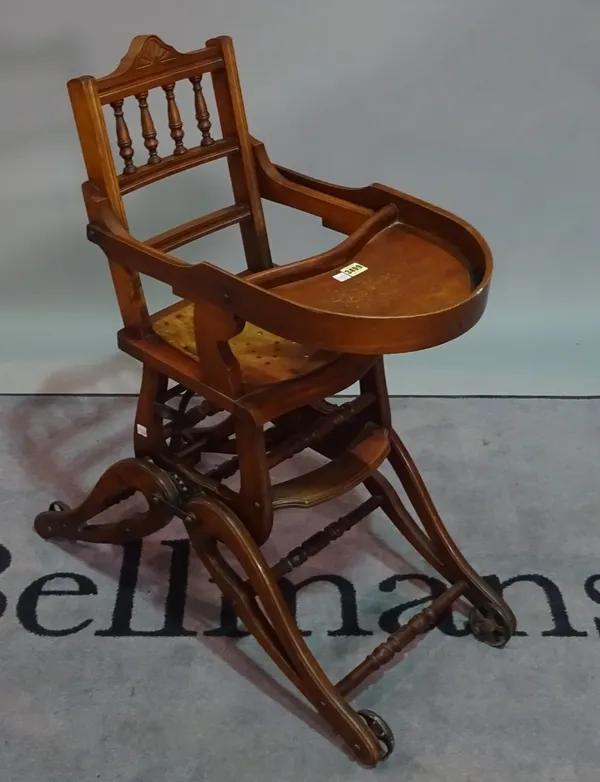 An early 20th century child's stained beech metamorphic high chair, 36cm wide x 100cm high.