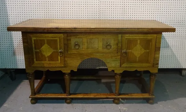 A modern oak and marble inlaid sideboard, with single frieze drawers flanked by cupboards, 145cm wide x 80cm high.