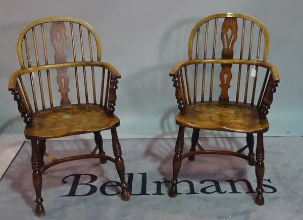 A pair of reproduction ash and elm Windsor elbow chairs, with pierced splats, on turned legs united by crinoline stretchers, approx 55cm wide x 94cm h