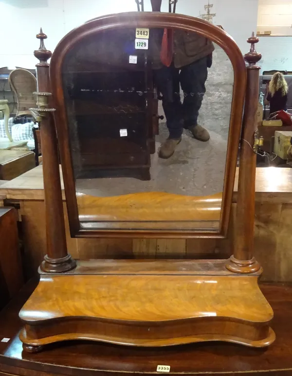 A large Victorian mahogany toilet mirror, with serpentine lift top base, 68cm wide x 86cm high.