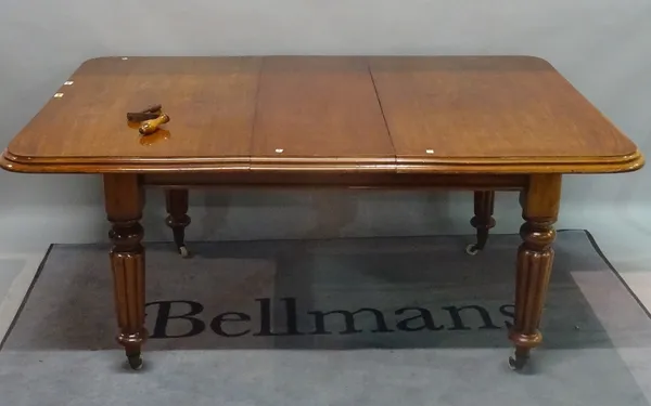 A Victorian mahogany extending dining table, on reeded supports, with one extra leaf, 112cm wide x 134cm long x 170cm long fully extended.