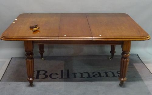 A Victorian mahogany extending dining table, on reeded supports, with one extra leaf, 112cm wide x 134cm long x 170cm long fully extended.