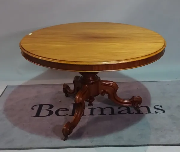 An early Victorian mahogany circular snap top table, on three scroll supports, 120cm diameter x 73cm high.