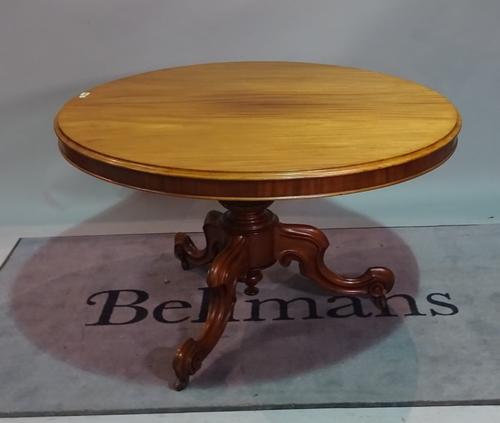 An early Victorian mahogany circular snap top table, on three scroll supports, 120cm diameter x 73cm high.