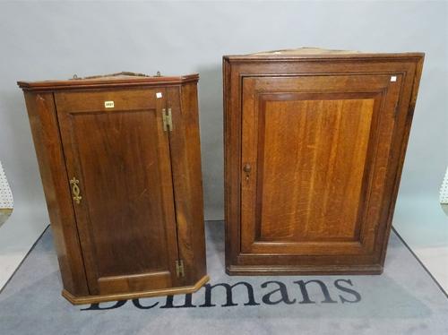 An 18th century and later oak hanging corner cupboard, 78cm wide x 103cm high, and another smaller, 68cm wide x 99cm high (2).