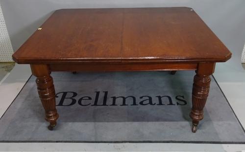 A late Victorian mahogany extending dining table, three extra leaves on reeded, turned supports, 140cm wide x 73cm high x 304cm fully extended.