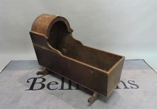 An 18th century style oak child's crib, 42cm wide x 74cm high.