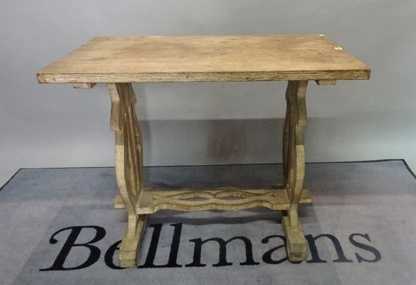 An early 20th century oak side table, on trestle end supports united by a stretcher, 91cm wide x 75cm high.