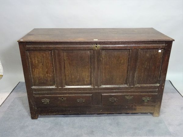 An 18th century and later oak lift top mule chest, with two drawers on block supports, 126cm wide x 80cm high.