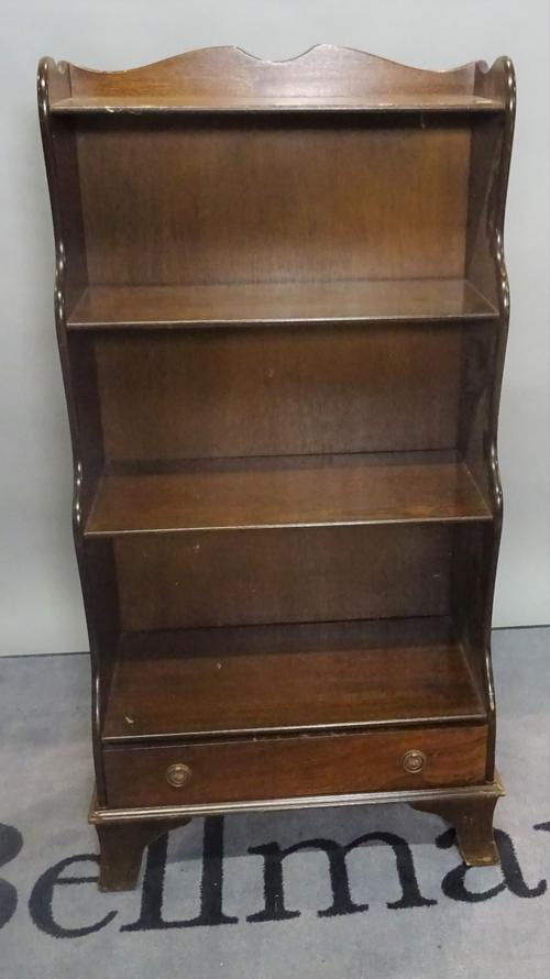 A modern stained beech waterfall bookcase, the single drawer base on bracket feet, 56cm wide x 114cm high.