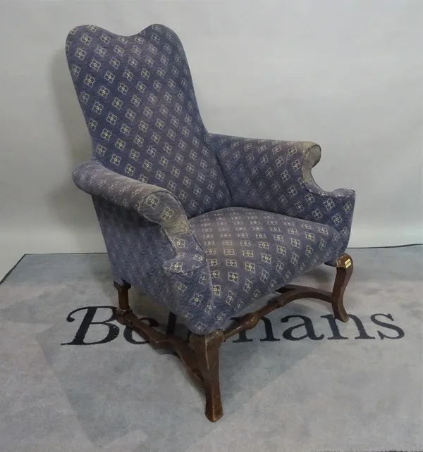 A late 19th century mahogany framed Continental blue upholstered armchair, on cabriole supports united by a turned stretcher, 82cm wide x 107cm high.