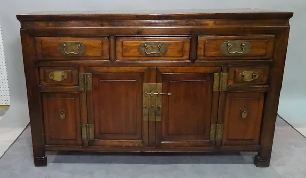 A Chinese stained beech sideboard, with three short drawers, over cupboard base, 140cm wide x 88cm high.