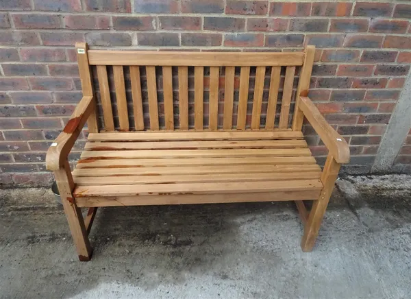 A modern hardwood garden bench, 120cm wide x 93cm high.