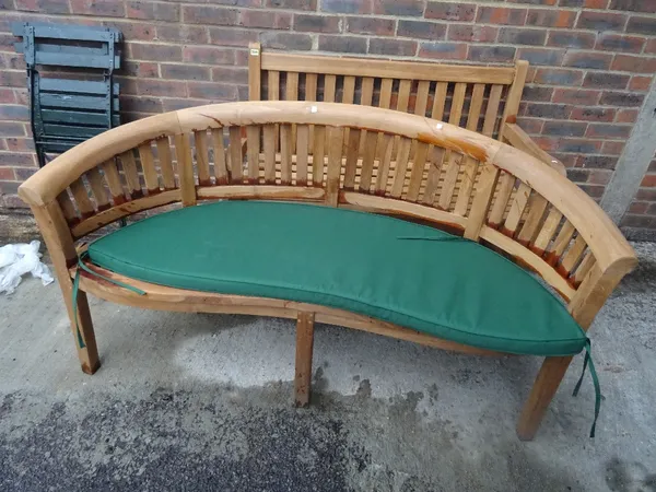 A modern hardwood garden bench with curved back, 160cm wide x 85cm high.