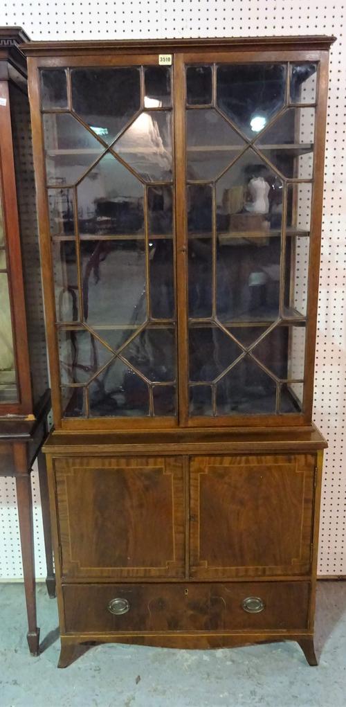 An Edwardian inlaid mahogany display cabinet, with astragal glazed doors with cupboard base, on bracket feet, 79cm wide x 182cm high.