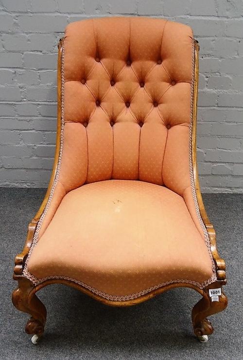 A Victorian walnut slipper back nursing chair, with serpentine seat on scroll supports, 55cm wide x 87cm high.