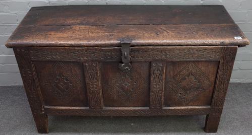 A late 17th century carved oak coffer, of panelled construction, with hinged top, lozenge carved front, on stile feet, 115cm wide x 65cm high, later...