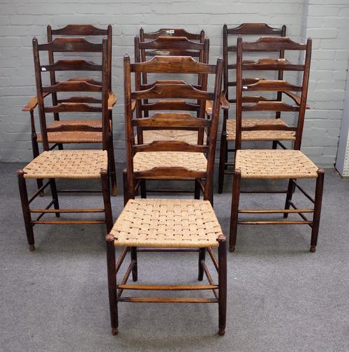 A harlequin set of seven ash ladder back dining chairs, 19th century, having high backs, on rounded legs united by stretchers, to include three open...
