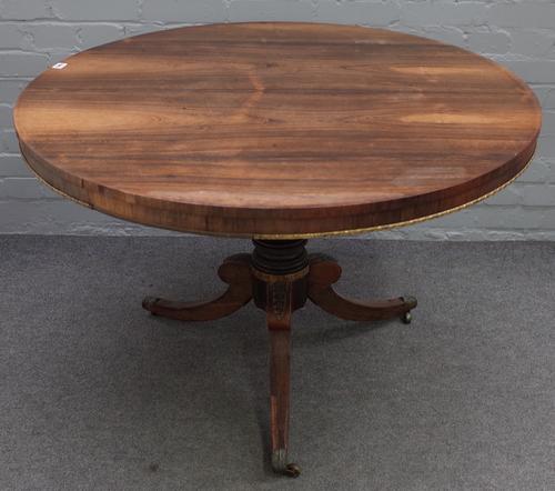 A Regency rosewood gilt metal mounted breakfast table, the circular tilt-top on a ring turned pillar and tripod base with castors, 105cm diameter x...