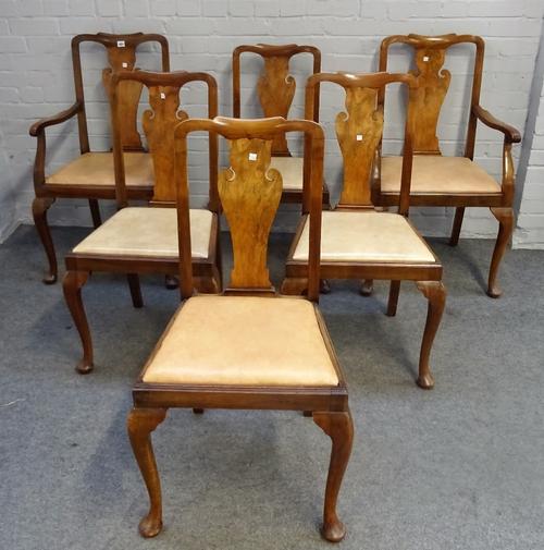 A set of twelve mid-20th century walnut vase back dining chairs on pad feet to include a pair of carvers, (12).