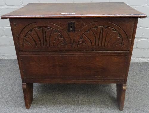 A small 17th century and later oak plank coffer, with carved front panel, on slab end supports, 54cm wide x 48cm high.