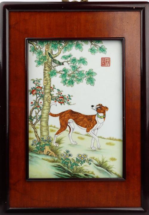 A late Chinese rectangular porcelain panel, painted with a hound looking up at a bird in branches after a scroll painting by Castiglione, iron-red...