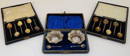 A set of six silver and varicoloured enamelled coffee spoons, with black bean finials to the handles, Birmingham 1950, another similar set of coffee...