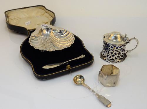 Silver, comprising; a Victorian mustard pot, with scroll pierced decoration and with a scallop form thumbpiece, London 1852, with a blue glass liner,...