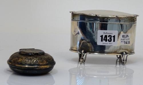 A silver oval hinge lidded tea caddy, raised on four wirework feet, Birmingham 1904, weight 162 gms and an Egyptian circular hinge lidded ashtray...