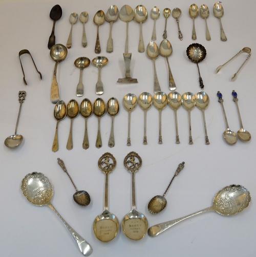 A group of silver flatware, comprising; two pairs of sugar tongs, a pair of preserve spoons, Sheffield 1896, a pair of West Kent Golf Club prize...