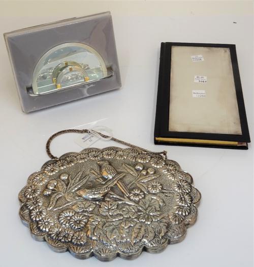 A shaped oval mirror embossed with two birds and a foliate spray within a floral surround, probably Turkish, width 21cm, with a box, a rectangular...