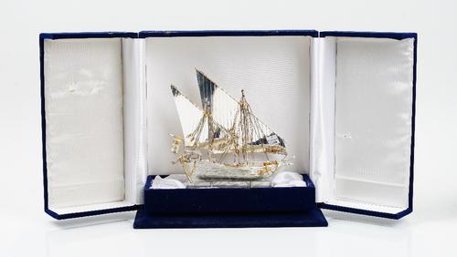 A model of a twin masted sailing ship, detailed 800, having gilt highlights, raised on a marble base, height including base 21.5cm, probably Italian,...