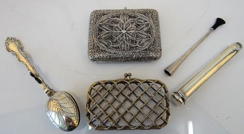 A rectangular filigree cigarette case, a rectangular lady's purse, of criss-cross ropetwist wirework design,(the interior lining lacking), detailed...