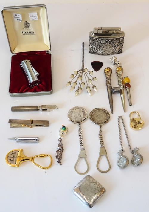 Two Egyptian key rings mounted with coins, a Gucci gilt metal key ring, two further key rings, a Ronson lighter with a case, a plated desk lighter, a...