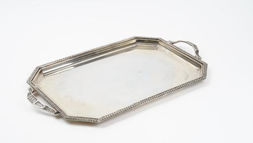 A plated on copper shaped rectangular twin handled tray, engraved with an armorial to the centre within a  floral and scroll moulded border, width...