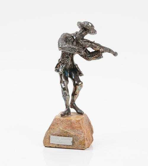 A loaded silver model of a performing fiddler, detailed 925, displayed on a rocky base having an applied plaque detailed Isaac Jeheskel Israel,...
