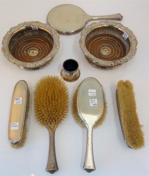 A silver mounted five piece dressing set, comprising; a hand mirror, two hairbrushes and two clothes brushes, mostly London 1930 and plated wares,...