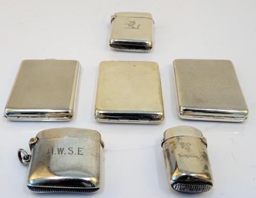 A Victorian silver vesta case, of curved oval form, Birmingham 1880, two further silver rectangular vesta cases, Birmingham 1895 and 1903, a...