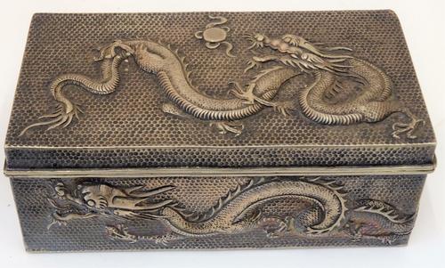 A Chinese rectangular table cigarette box, wooden lined within, the exterior decorated with dragons, marked W.H 90, size 16cm x 8.5cm.