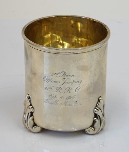 A late 17th century style silver cylindrical cup, Thomas, New Bond St, London 1905, on three leaf scroll feet, 9.5cm high, weight 211 gms, inscribed...
